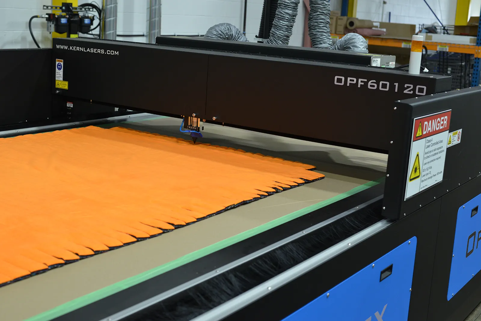 Laser cutting fleece blanket strips on a Kern OPF60120 machine at Kinetyc’s Wixom facility.