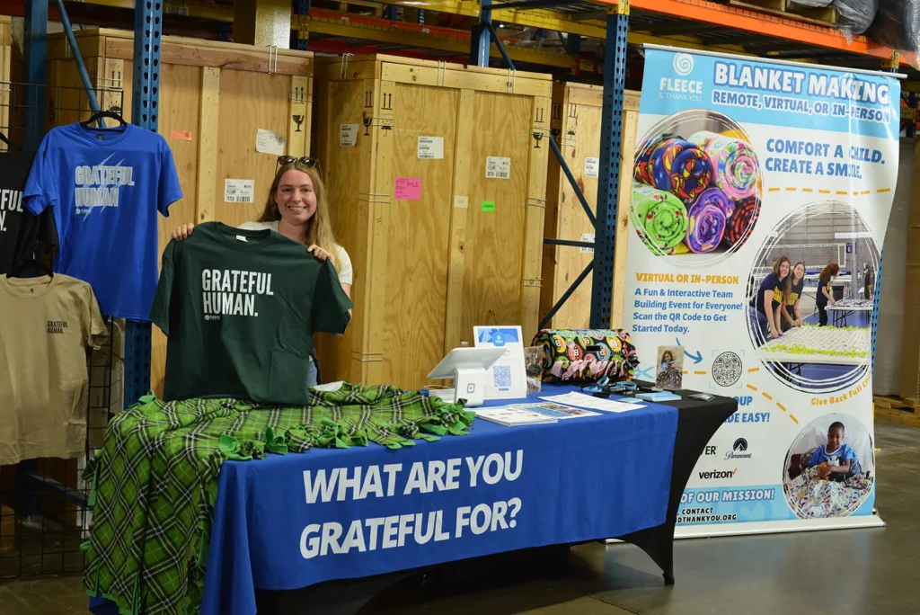 Fleece & Thank You booth with “Grateful Human” apparel and blanket-making kits at Kinetyc’s Open House