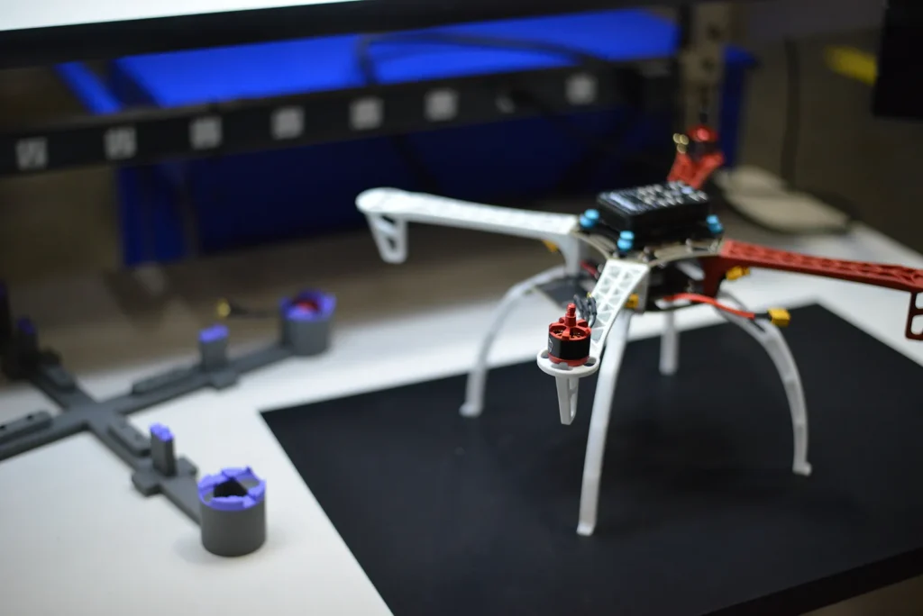 Assembled quadcopter drone on workbench in assembly workspace.