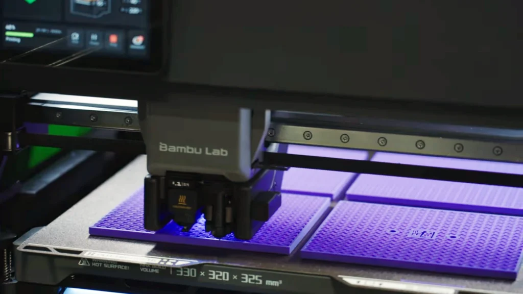 Bambu Lab 3D printer producing custom manufacturing components using additive manufacturing technology.