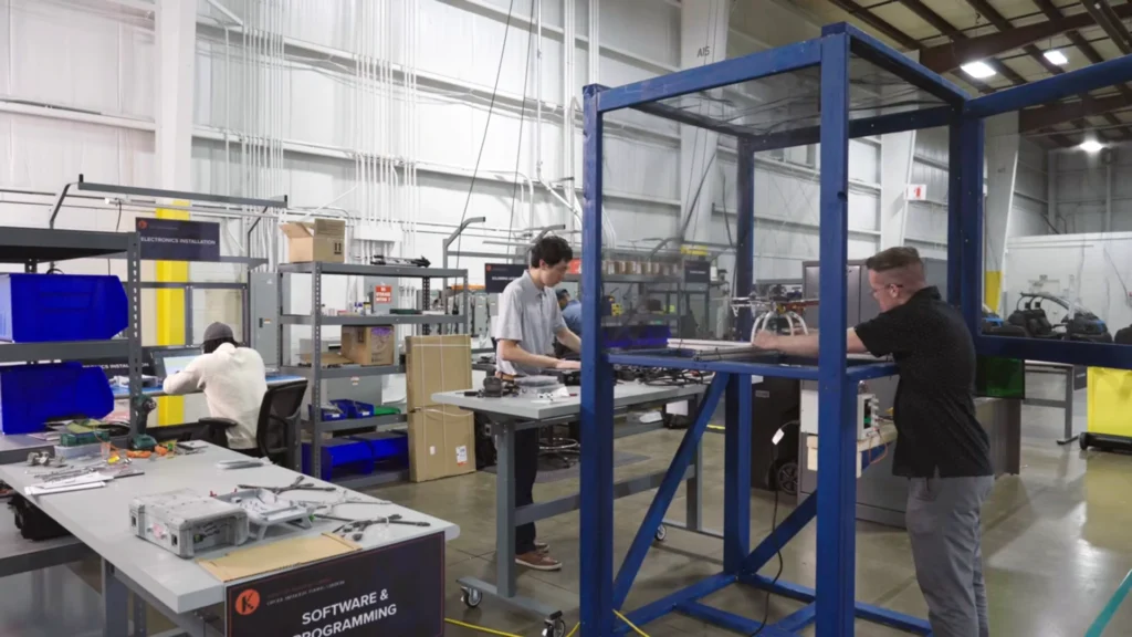 Technicians assembling and testing drone systems within a dedicated manufacturing cell at Kinetyc's Wixom facility.