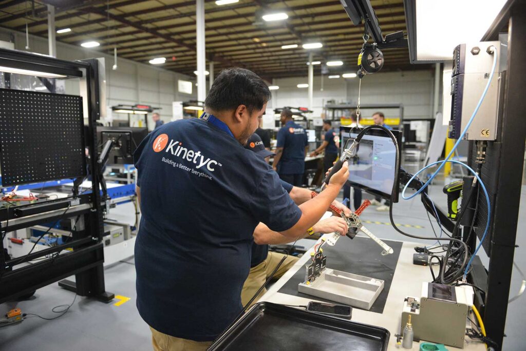 Kinetyc team member demonstrates an assembly process during the 2026 Kinetyc Open House.