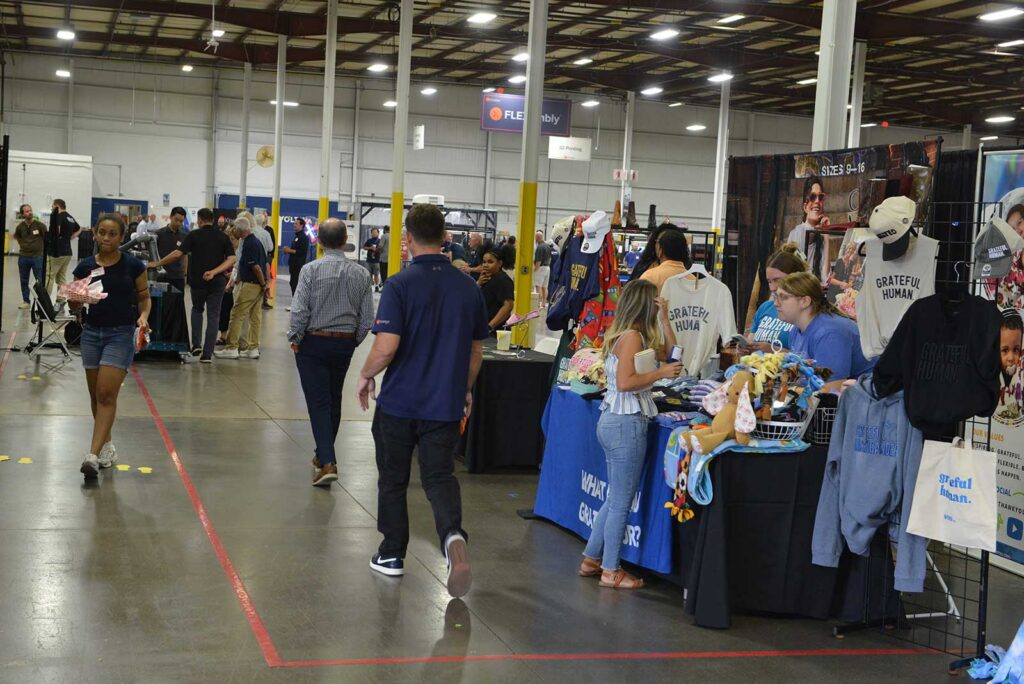 Guests visit partner and community exhibits during the 2026 Kinetyc Open House in Wixom, Michigan.